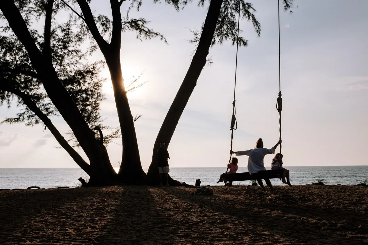 Family together at sunset by the sea